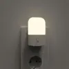 A white LED night light plugged into a wall socket. Produktbild-Vorschau