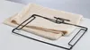 A beige fabric mat and black metal frame for a cat hammock designed to hang on a radiator. Podgląd zdjęcia produktu