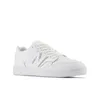 A white New Balance sneaker is shown from a side-angle against a white background. Podgląd zdjęcia produktu