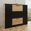 A shoe cabinet with three drawers and two side doors, placed on a wooden floor against a concrete wall. Produktbild-Vorschau