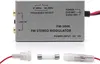 A silver FM stereo modulator with cables and a fuse in front of a white background. Produktbild-Vorschau