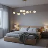 A bedroom scene with a bed, nightstands, and a chandelier. Náhľad obrázku produktu