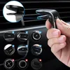 A hand holding a black magnetic car vent phone mount, with several circular insets showing different types of car vents and compatibility checks. Voir les images du produit
