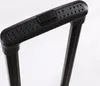 Close-up of a black suitcase handle with textured grip and a release button. Produktbild-Vorschau