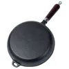A cast iron frying pan with a wooden handle, viewed from the underside. Podgląd zdjęcia produktu