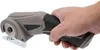 A hand holding a cordless electric scissors. Náhled obrázku produktu