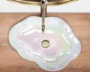 A top-down view of a pearlescent cloud-shaped sink with a gold faucet. Náhľad obrázku produktu