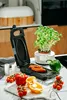 A kitchen counter with a grill, vegetables, and a potted plant. Náhľad obrázku produktu
