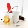 A collection of cleaning supplies arranged on a wooden surface against a white background. Anteprima dell’immagine prodotto