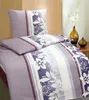 A bed with a pillow and duvet cover set, styled on a bed with decorative vases in the background. Produktbild-Vorschau
