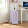 A lilac roll container with five drawers is placed next to a white desk in a room with a window and sheer curtains. Voir les images du produit