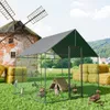 A chicken coop with chickens and ducks in a grassy field with a windmill and hay bales in the background. Náhled obrázku produktu