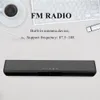 A soundbar is placed on a desk next to a keyboard, coffee cup, and pencil, with text overlay describing its features. Produktbild-Vorschau