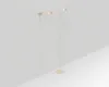 A minimalist product shot of a floor lamp and a wall lamp against a light gray and white background. Produktbild-Vorschau
