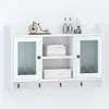 A white wall-mounted cabinet with glass doors is shown, displaying decorative items and storage boxes. Podgląd zdjęcia produktu