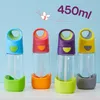 Four colorful drink bottles lined up against a light blue background with a small butterfly graphic. Náhled obrázku produktu
