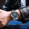 A man's wrist wearing a silver and blue chronograph watch, with a black leather jacket and blue denim jeans visible. Produktbild-Vorschau