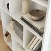 A close-up view of a white bookshelf filled with decorative items and books. Produktbild-Vorschau