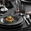 A close-up of a beautifully set table with a plate of food, cutlery, and a glass. Anteprima dell’immagine prodotto