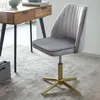 A gray velvet office chair with a gold base is shown next to a wooden desk. Voir les images du produit