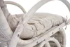 Close-up of a white rattan rocking chair with a cream cushion. Produktbild-Vorschau
