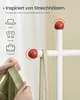 A close-up of a white coat rack with red spherical knobs, showing a hand holding a green garment and a beige bag strap hanging from one of the knobs. Text overlays describe the design inspiration and suggested uses. Produktbild-Vorschau