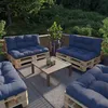 An outdoor patio seating area with pallet furniture and cushions. Voir les images du produit