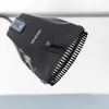 A close-up, studio shot of a black hair dryer attachment with bristles. Produktbild-Vorschau