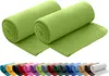 Two rolled-up green fleece blankets are displayed prominently, with a row of various colored rolled blankets shown below. Produktbild-Vorschau