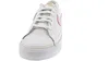 A close-up, front-facing view of a white Nike Court Legacy sneaker with pink accents. Voir les images du produit