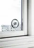 A thermometer is attached to a window, showing the temperature outside. Podgląd zdjęcia produktu