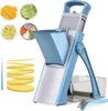 A blue and silver vegetable slicer with various chopped vegetables and sliced oranges in small bowls, along with sliced potatoes, is displayed against a white background. A cleaning brush is also visible. Produktbild-Vorschau