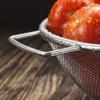 Close-up of wet tomatoes in a metal colander on a wooden surface. Anteprima dell’immagine prodotto