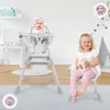 Two children are shown in a nursery or playroom setting. One baby is in a high chair, and a toddler is sitting on a chair holding a stuffed animal. Podgląd zdjęcia produktu
