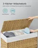 A person's hands are shown opening the lid of a woven laundry basket with three compartments, each containing different colored laundry. Produktbild-Vorschau