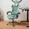 A green and white gaming chair is shown in a room with a desk. Produktbild-Vorschau