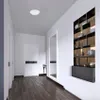 A hallway with doors and a decorative shelf. Voir les images du produit