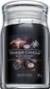 A Yankee Candle Black Coconut scented candle in a glass jar with a black label. Produktbild-Vorschau