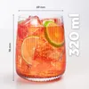 A close-up of a glass filled with an orange beverage, ice, and lime slices, with dimensions and volume indicated. Produktbild-Vorschau