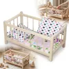 Ein Puppenbett aus Holz in einer natürlichen Farbe mit Produktbild-Vorschau 1