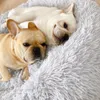 Two French Bulldogs are resting on a fluffy gray dog bed. Produktbild-Vorschau