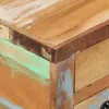 A close-up view of the corner of a wooden table with a distressed, multi-colored finish. Produktbild-Vorschau