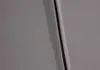 A close-up view of a seam and zipper on a light gray textured surface, likely upholstery. Produktbild-Vorschau