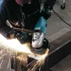 A person using an angle grinder to cut metal, creating sparks. Produktbild-Vorschau