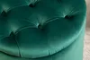 A close-up view of a tufted, dark green velvet ottoman. Produktbild-Vorschau
