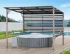 An outdoor patio with a hot tub under a pergola, next to a swimming pool. Produktbild-Vorschau
