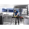 A man is using a jigsaw in a workshop or industrial kitchen setting. Voir les images du produit