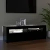 A black TV stand with a DVD player and books on it, in front of a wall with a TV and a plant. Anteprima dell’immagine prodotto