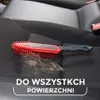 A red and gray brush with collected pet hair on a black car seat. Podgląd zdjęcia produktu