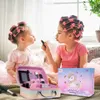 Two young girls with hair rollers are playing with makeup, one applying lipstick to the other. A makeup case and a box with a unicorn design are in the foreground. Voir les images du produit